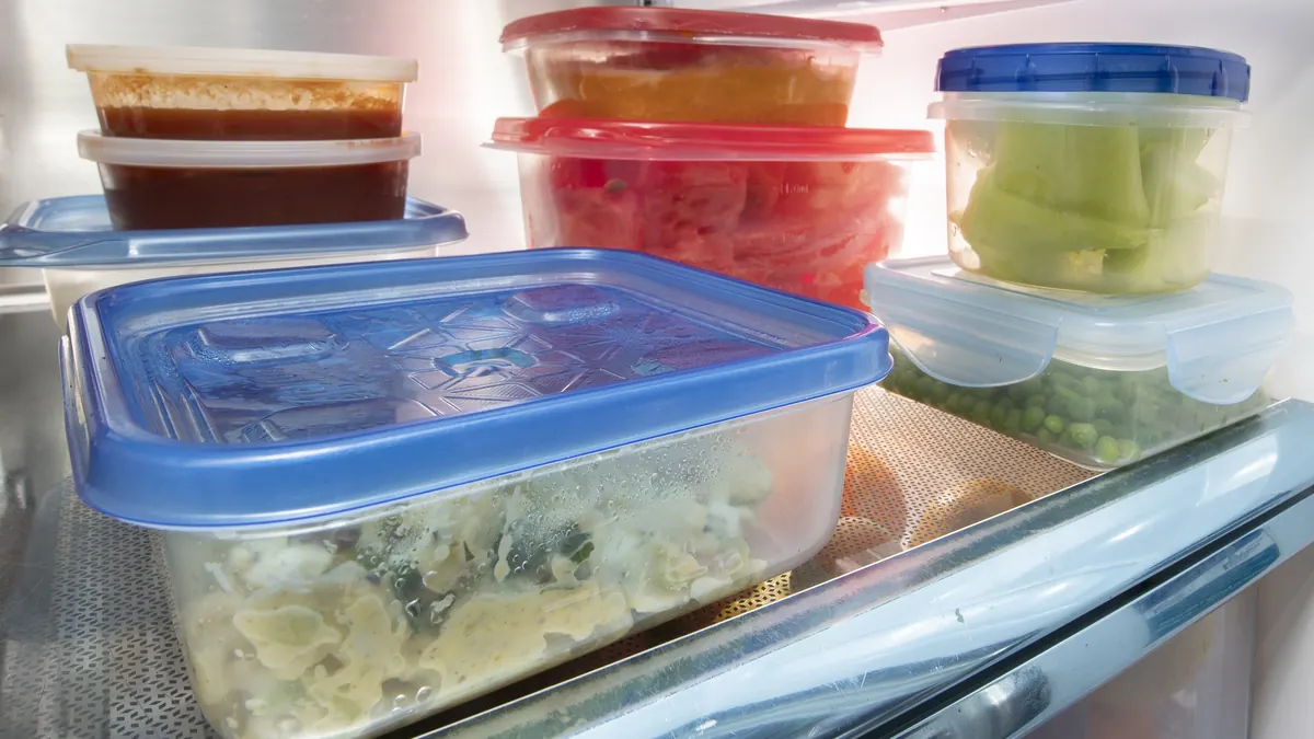 Leftovers stored in clear lidded containers on a refrigerator shelf